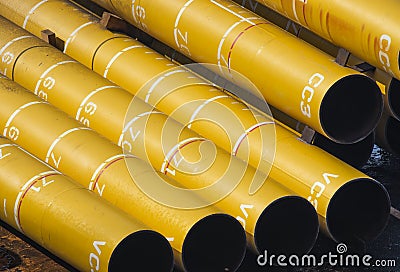 Yellow big huge pipes on the barge offshore Stock Photo