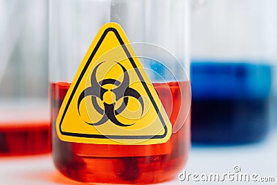 Yellow Biohazzard sign on Chemical Glassware in Lab Stock Photo