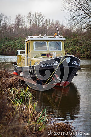 A yellow black boat in the water Editorial Stock Photo