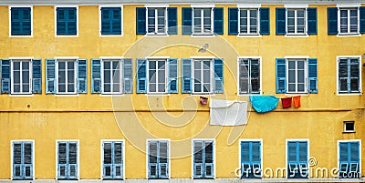 Yellow and blue facade with laundry in Bastia Corsica Stock Photo