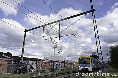 Yellow blue Metro Train (motion blur) runs in the Brunswick suburb of Melbourne, Australia Editorial Stock Photo