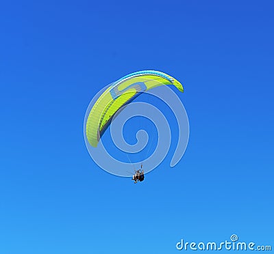 Yellow blue paraglider on blue sky. Editorial Stock Photo