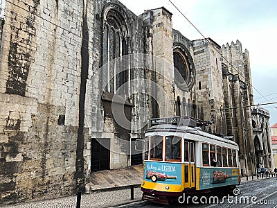 Yellow blue retro tram old historic building cloudy day lisbon portugal Editorial Stock Photo