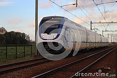 Yellow blue train type SLT sprinter of dutch Railways NS on the train bridge of Gouda in the Netherlands Editorial Stock Photo