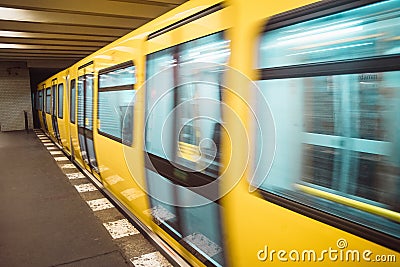 Yellow blurred subway train in Berlin Stock Photo
