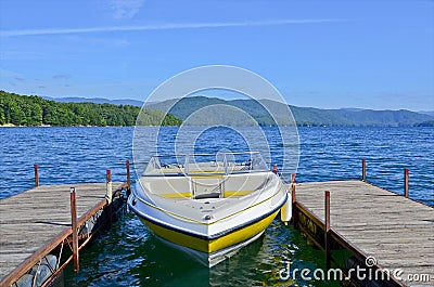 Yellow Boat at Dock on a Lake Stock Photo