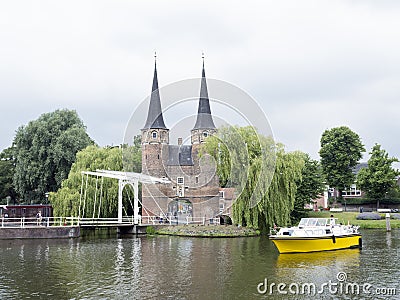 Yellow boat waits for bridge to open near oostpoort in old dutch Editorial Stock Photo