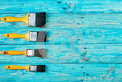 Yellow brush on a blue wooden background Stock Photo