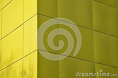 Yellow building is lined with square panels of plastic, fiberglass. fastened with screws. Washable walls is a major advantage. on Stock Photo