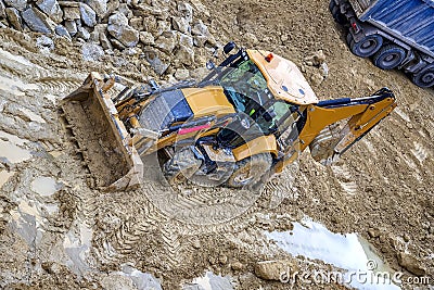 Yellow bulldozer in loam soil Stock Photo