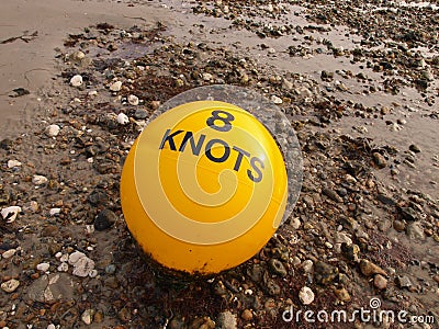 Yellow Buoy on the beach Stock Photo