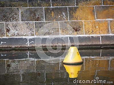 Yellow Buoy Floating In A Canal In Berlin Stock Photo