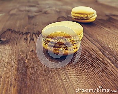 Yellow cake macaron on wood background, maccarone sweet dessert Stock Photo