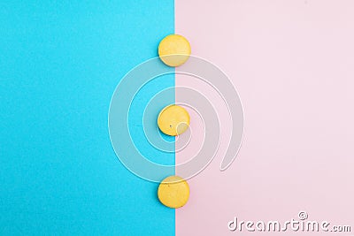 Yellow cakes on blue and pink background Stock Photo