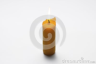 Yellow candle isolated on a white background Stock Photo