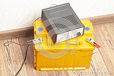 yellow car battery with car battery charger Stock Photo