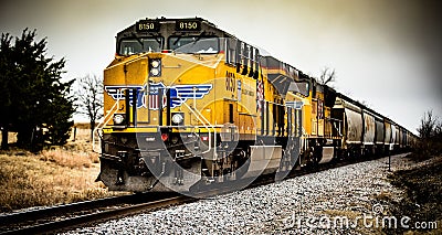 Yellow cargo freight train on tracks in Allen, USA Editorial Stock Photo