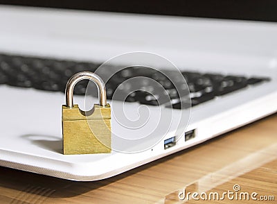 Yellow castle stands on a white laptop Stock Photo