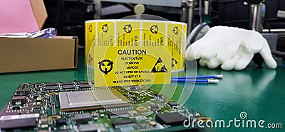 The yellow CAUTION label for Electrostatic Sensitive Devices ESD on static free workstation Stock Photo