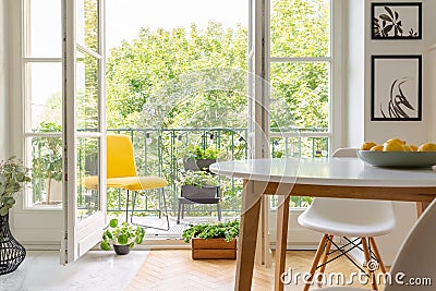 Yellow chair on the balcony of elegant kitchen interior, real photo Stock Photo