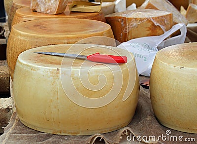 Yellow cheese on sale from milkman into a village fair Stock Photo