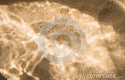 Yellow clean sand with wavy patterns under clear water Stock Photo