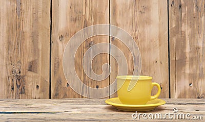 Yellow coffee cup and saucer Stock Photo