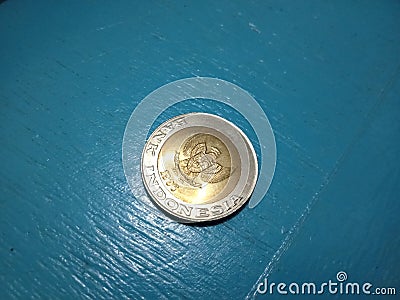 Yellow coin rupiah from indoneia on top view in 1992 year Stock Photo