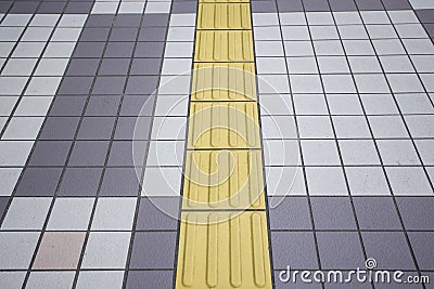 Yellow color blind floor tiles on public walkway Stock Photo