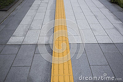 Yellow color blind floor tiles on public walkway Stock Photo