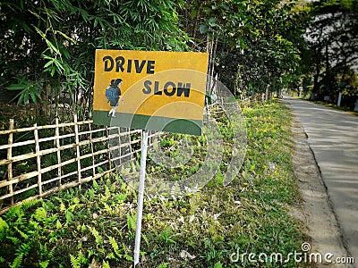 Yellow color school ahead sign board near the road Stock Photo