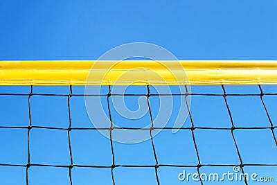 yellow colored summer games ball background beach volleyball or tennis net against blue sky for sport events. copyspace. copy Stock Photo