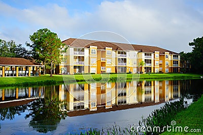 Yellow condos or apartments and a small pond Stock Photo