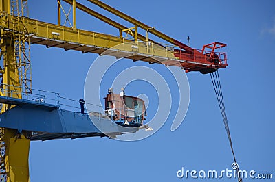 Yellow crane in the harbor of Amsterdam unloading a ship Stock Photo