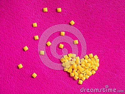 Yellow crystal craft handmade heart shape for diamond embroidery hobby rhinestone. Background with bright leather texture. Pink Stock Photo