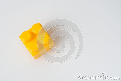 Yellow cube block constructor on a white background with copy space. Construction idea concept Stock Photo