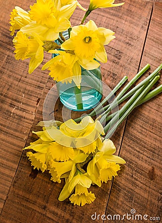 Yellow dafodills on wooden table Stock Photo