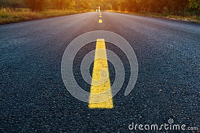 Yellow dashed line on empty asphalt road Stock Photo