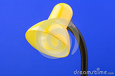 Yellow desk lamp isolated on blue background Stock Photo