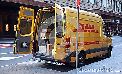 Yellow DHL car parked in Sydney CBD area. Express courier delivery of mail, parcels and documents Editorial Stock Photo