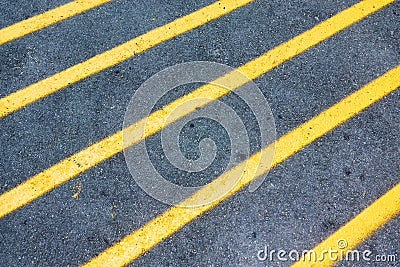 Yellow diagonal lines marking on asphalt road Stock Photo