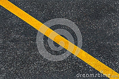 Yellow diagonal marking line on the asphalt road Stock Photo