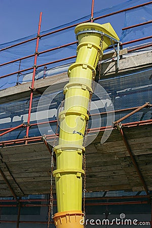 Yellow discharge chute construction debris Stock Photo