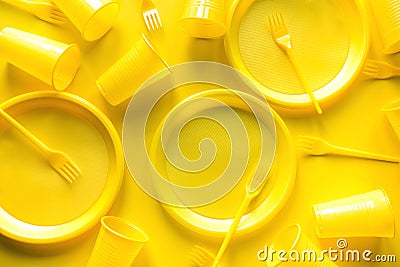 Yellow disposable picnic utensils. Environment, eco friendly discarded, plastic, garbage, collection for recycle concept.Top view Stock Photo