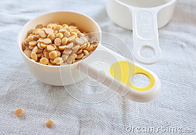 Yellow Dried Soybeans in A Measuring Spoon Stock Photo