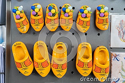 Yellow Dutch clogs magnets as souvenirs from the Netherlands, for travellers. Says Holland and some have wooden tulips. In a Editorial Stock Photo