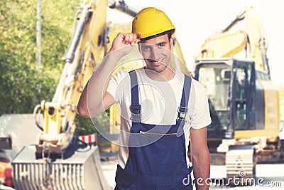 Yellow earthmover with handsome latin american construction work Stock Photo