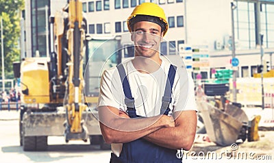 Yellow earthmover with strong latin american construction worker Stock Photo