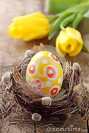 Yellow easter egg in nest Stock Photo