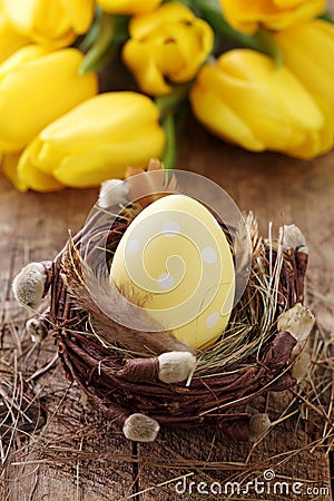 Yellow easter egg in nest Stock Photo